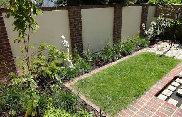 Old town courtyard back wall with render and brick pillars - Carol Whitehead garden design