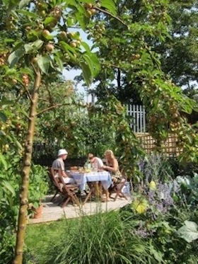 al fresco dining in garden with crab apple tree in foreground