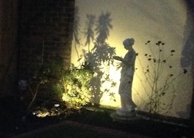 night lit statue in courtyard garden