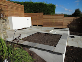 contemporary terracing with rendered white walls, venetian trellis, waiting for plants