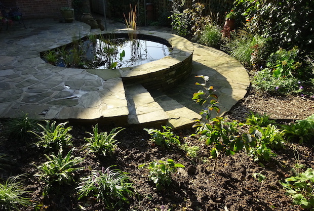 circular raised pond of recycled York stone